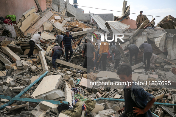 A Palestinian man is reacting as he searches for casualties at the site of an Israeli strike on a house, amid the ongoing conflict between I...