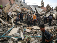 A Palestinian man is reacting as he searches for casualties at the site of an Israeli strike on a house, amid the ongoing conflict between I...