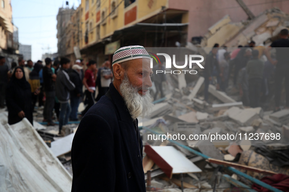 A Palestinian man is reacting as he searches for casualties at the site of an Israeli strike on a house, amid the ongoing conflict between I...