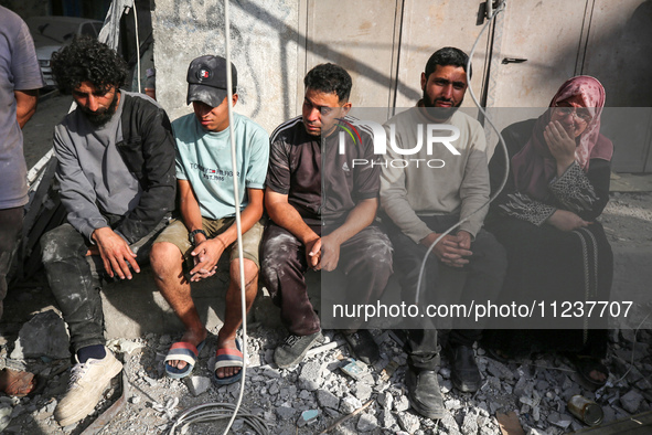 A Palestinian man is reacting as he searches for casualties at the site of an Israeli strike on a house, amid the ongoing conflict between I...