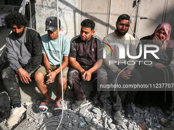 A Palestinian man is reacting as he searches for casualties at the site of an Israeli strike on a house, amid the ongoing conflict between I...