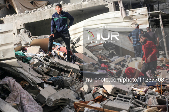 A Palestinian man is reacting as he searches for casualties at the site of an Israeli strike on a house, amid the ongoing conflict between I...