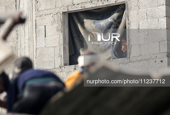 A Palestinian man is reacting as he searches for casualties at the site of an Israeli strike on a house, amid the ongoing conflict between I...