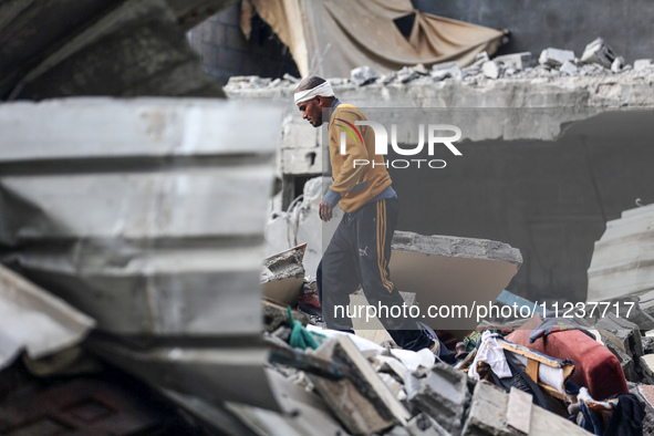 A Palestinian man is reacting as he searches for casualties at the site of an Israeli strike on a house, amid the ongoing conflict between I...