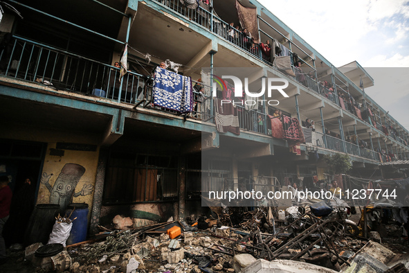 Palestinians are inspecting the site of an Israeli strike on a school sheltering displaced people, amid the ongoing conflict between Israel...