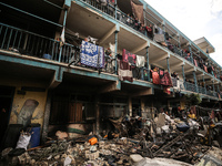 Palestinians are inspecting the site of an Israeli strike on a school sheltering displaced people, amid the ongoing conflict between Israel...