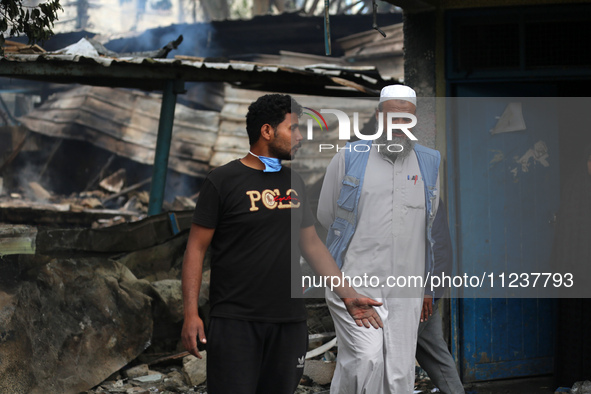 A Palestinian employee of UNRWA is looking at damages at the site of an Israeli strike on a school sheltering displaced people, amid the ong...