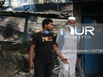 A Palestinian employee of UNRWA is looking at damages at the site of an Israeli strike on a school sheltering displaced people, amid the ong...