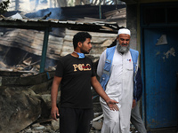 A Palestinian employee of UNRWA is looking at damages at the site of an Israeli strike on a school sheltering displaced people, amid the ong...