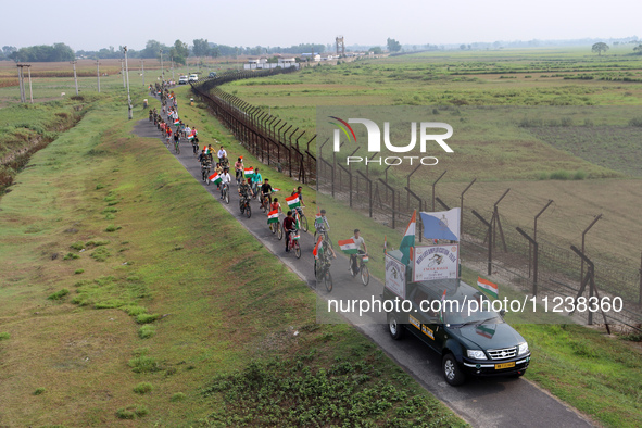 Indian Border Security Force (BSF) personnel, along with the youths, are taking part in a cycle awareness rally at the India-Bangladesh bord...