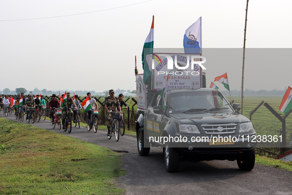 Indian Border Security Force (BSF) personnel, along with the youths, are taking part in a cycle awareness rally at the India-Bangladesh bord...