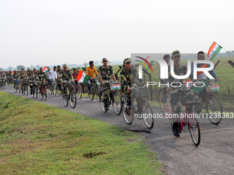 Indian Border Security Force (BSF) personnel, along with the youths, are taking part in a cycle awareness rally at the India-Bangladesh bord...