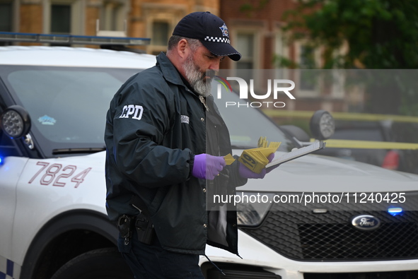 A crime scene investigator is on the scene. Two people are being shot in Chicago, Illinois, United States, on May 14, 2024. In the 9000 bloc...