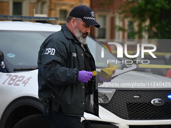 A crime scene investigator is on the scene. Two people are being shot in Chicago, Illinois, United States, on May 14, 2024. In the 9000 bloc...