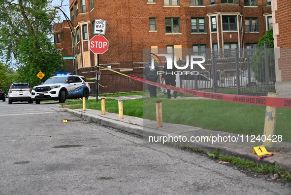 Shell casings are being seen next to evidence markers at the crime scene. Two people are being shot in Chicago, Illinois, United States, on...