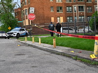 Shell casings are being seen next to evidence markers at the crime scene. Two people are being shot in Chicago, Illinois, United States, on...