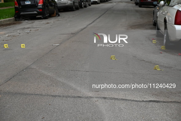 Shell casings are being seen next to evidence markers at the crime scene. Two people are being shot in Chicago, Illinois, United States, on...