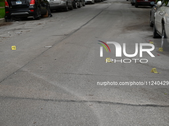 Shell casings are being seen next to evidence markers at the crime scene. Two people are being shot in Chicago, Illinois, United States, on...