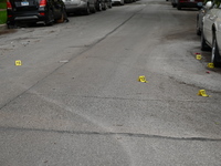 Shell casings are being seen next to evidence markers at the crime scene. Two people are being shot in Chicago, Illinois, United States, on...