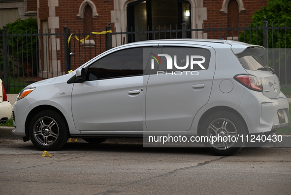 A vehicle window is being damaged with a bullet hole at the crime scene. Two people are being shot in Chicago, Illinois, United States, on M...