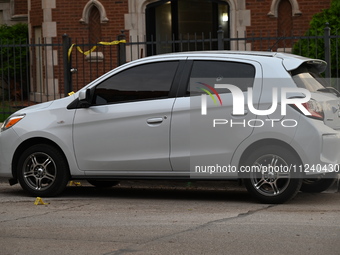 A vehicle window is being damaged with a bullet hole at the crime scene. Two people are being shot in Chicago, Illinois, United States, on M...