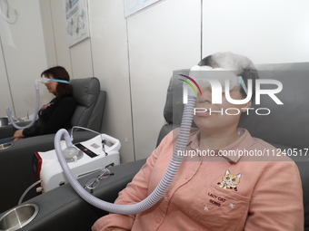 Patients are having their eyes fumigated with traditional Chinese medicine at the ophthalmology department of Shaoxing Central Hospital in S...