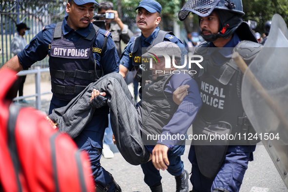 Nepal Police are arresting a differently able person as they protest in Kathmandu, Nepal, on May 15, 2024. 