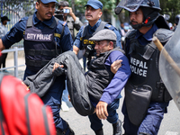 Nepal Police are arresting a differently able person as they protest in Kathmandu, Nepal, on May 15, 2024. (