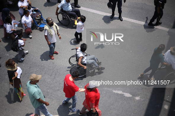 Nepali wheelchair users are rallying on the roads of Kathmandu, Nepal, on May 15, 2024, demanding the government address their demand for eq...