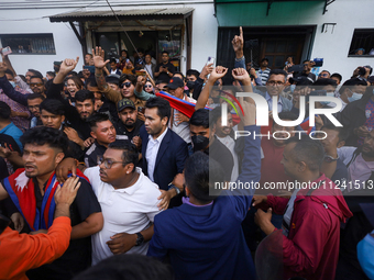 Supporters and fans of Sandeep Lamichhane are reacting and celebrating outside the Patan High Court after hearing the news of acquittal from...