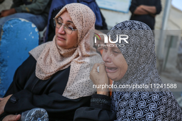 Palestinians are mourning their relatives, killed in an overnight Israeli strike on the Al-Breij refugee camp, during a mass funeral at the...