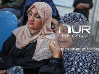 Palestinians are mourning their relatives, killed in an overnight Israeli strike on the Al-Breij refugee camp, during a mass funeral at the...