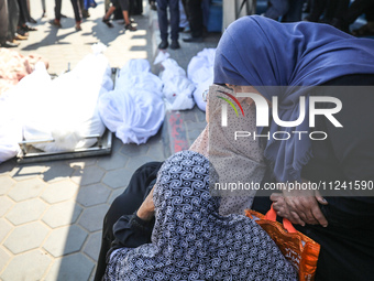 Palestinians are mourning their relatives, killed in an overnight Israeli strike on the Al-Breij refugee camp, during a mass funeral at the...