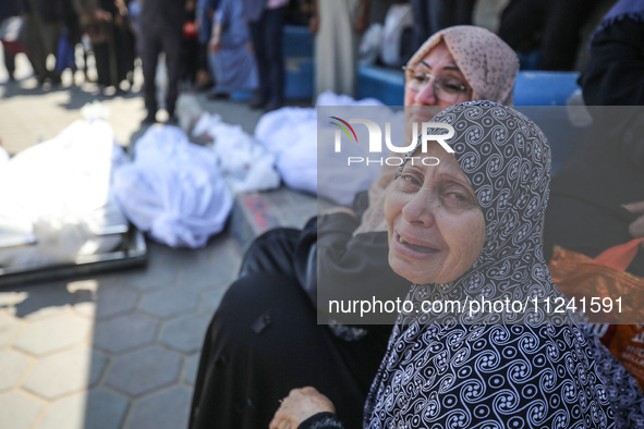 Palestinians are mourning their relatives, killed in an overnight Israeli strike on the Al-Breij refugee camp, during a mass funeral at the...