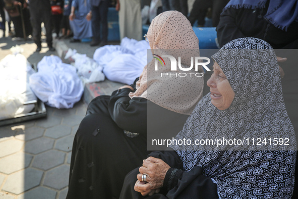 Palestinians are mourning their relatives, killed in an overnight Israeli strike on the Al-Breij refugee camp, during a mass funeral at the...