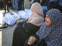 Palestinians are mourning their relatives, killed in an overnight Israeli strike on the Al-Breij refugee camp, during a mass funeral at the...