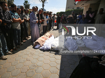 Palestinians are mourning their relatives, killed in an overnight Israeli strike on the Al-Breij refugee camp, during a mass funeral at the...