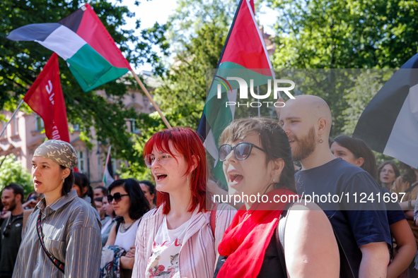 Students of Jagiellonia University  chant pro-Palestine slogans and hold Palestinian flags and banners during academia demonstration against...