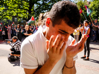 Hamza, a young man who fled Gaza 10 days ago shows his emotions after he spoke during an academia demonstration against Israeli actions bein...