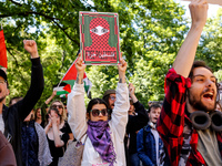 Students of Jagiellonia University  chant pro-Palestine slogans and hold Palestinian flags and banners during academia demonstration against...