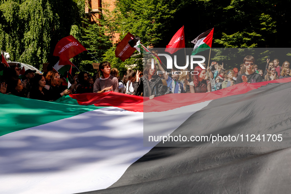 Students of Jagiellonia University  chant pro-Palestine slogans and hold Palestinian flags and banners during academia demonstration against...