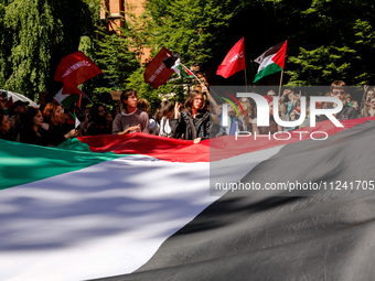 Students of Jagiellonia University  chant pro-Palestine slogans and hold Palestinian flags and banners during academia demonstration against...