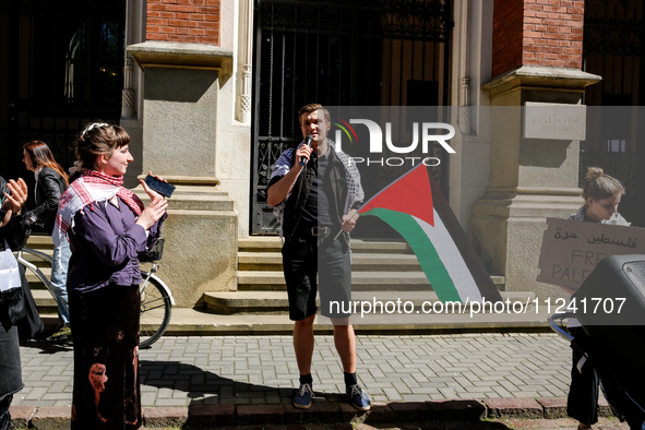 Organisers peak and hold Palestinian flags and banners during academia demonstration against Israeli actions being taken in the Gaza Strip i...