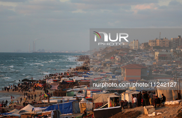 Tents and shacks are housing displaced Palestinians crowding the Mediterranean seashore in Deir el-Balah in the central Gaza Strip on May 15...