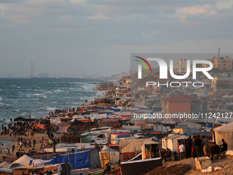 Tents and shacks are housing displaced Palestinians crowding the Mediterranean seashore in Deir el-Balah in the central Gaza Strip on May 15...