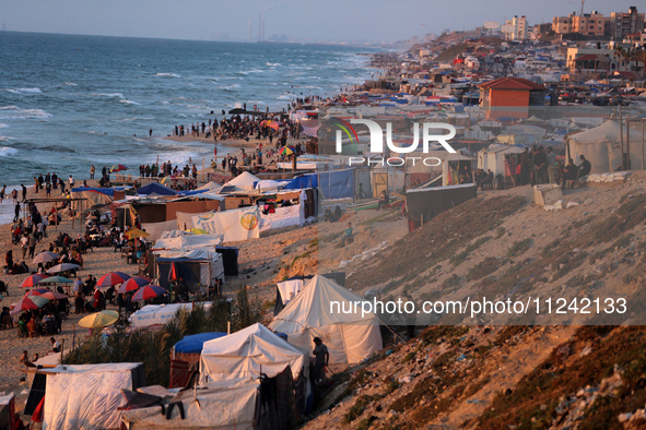 Tents and shacks are housing displaced Palestinians crowding the Mediterranean seashore in Deir el-Balah in the central Gaza Strip on May 15...