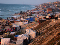 Tents and shacks are housing displaced Palestinians crowding the Mediterranean seashore in Deir el-Balah in the central Gaza Strip on May 15...