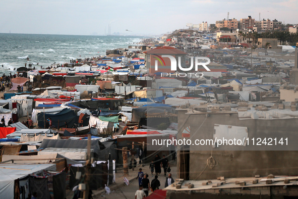 Tents and shacks are housing displaced Palestinians crowding the Mediterranean seashore in Deir el-Balah in the central Gaza Strip on May 15...