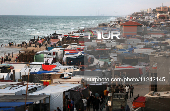 Tents and shacks are housing displaced Palestinians crowding the Mediterranean seashore in Deir el-Balah in the central Gaza Strip on May 15...