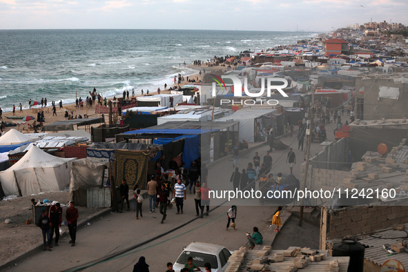 Tents and shacks are housing displaced Palestinians crowding the Mediterranean seashore in Deir el-Balah in the central Gaza Strip on May 15...